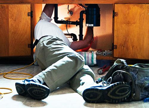 worker fixing sink